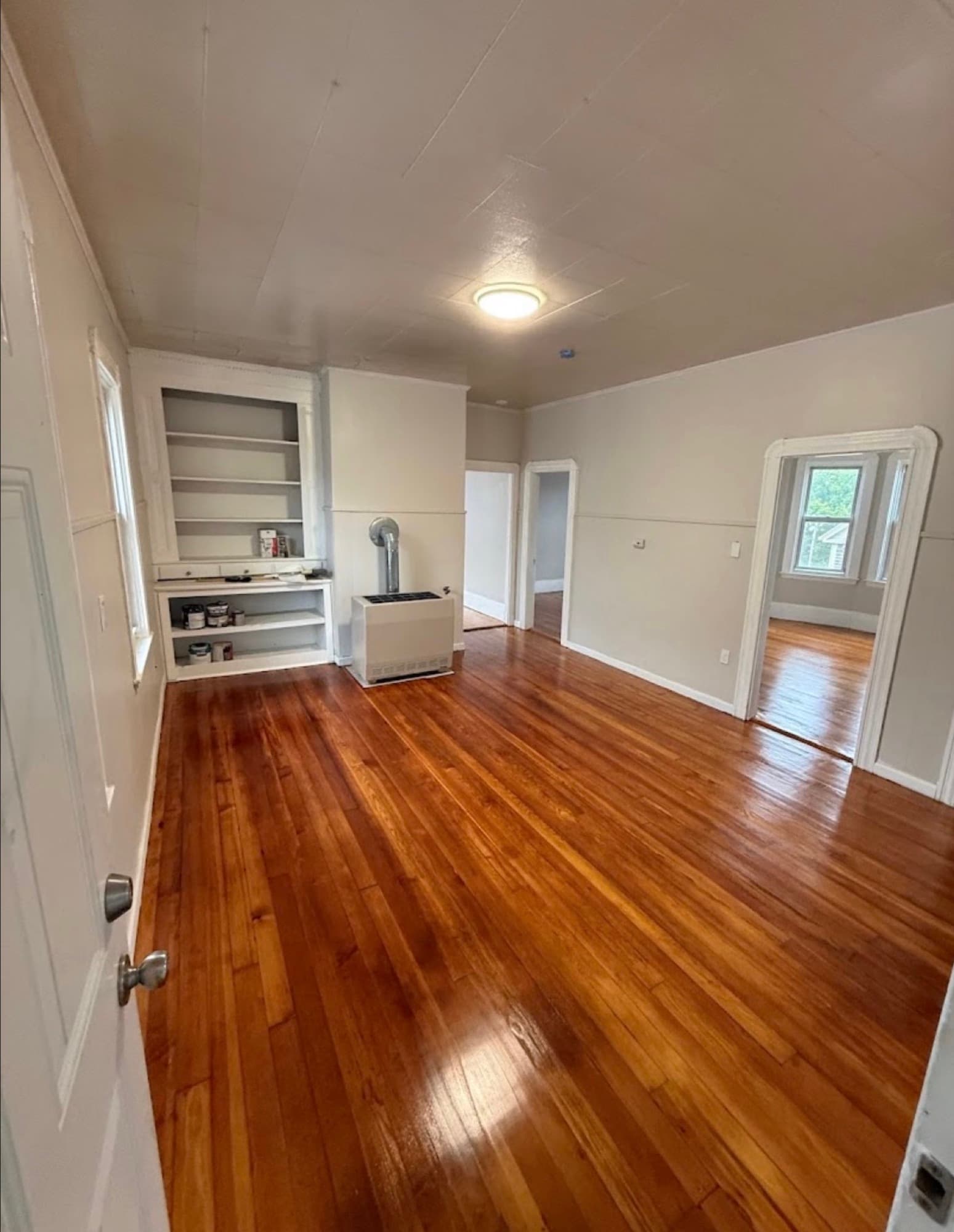 Refinished hardwood floors and built-in shelving by Harborview Home Improvements
